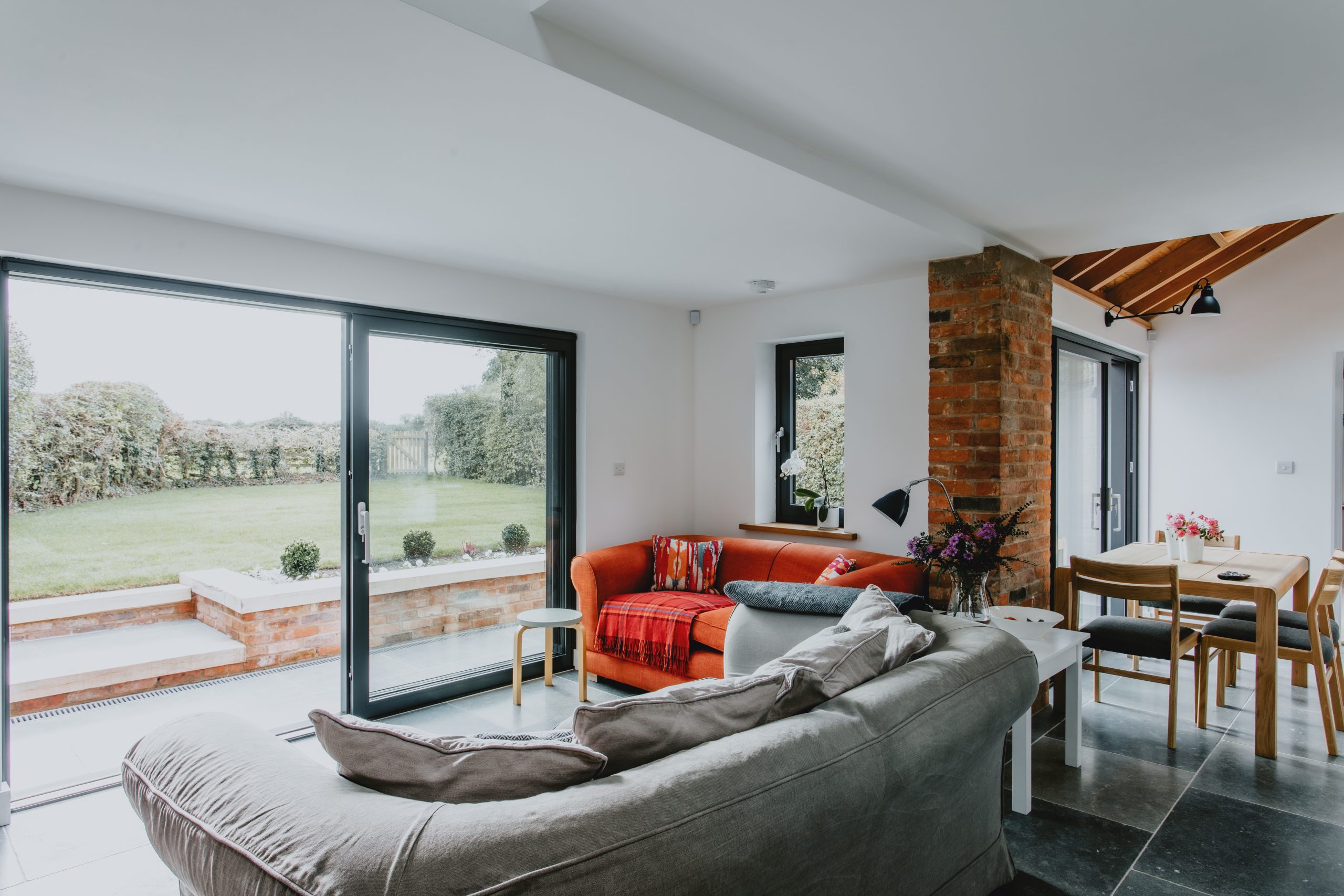 Open-plan living room with large aluminium sliding doors looking out to the garden