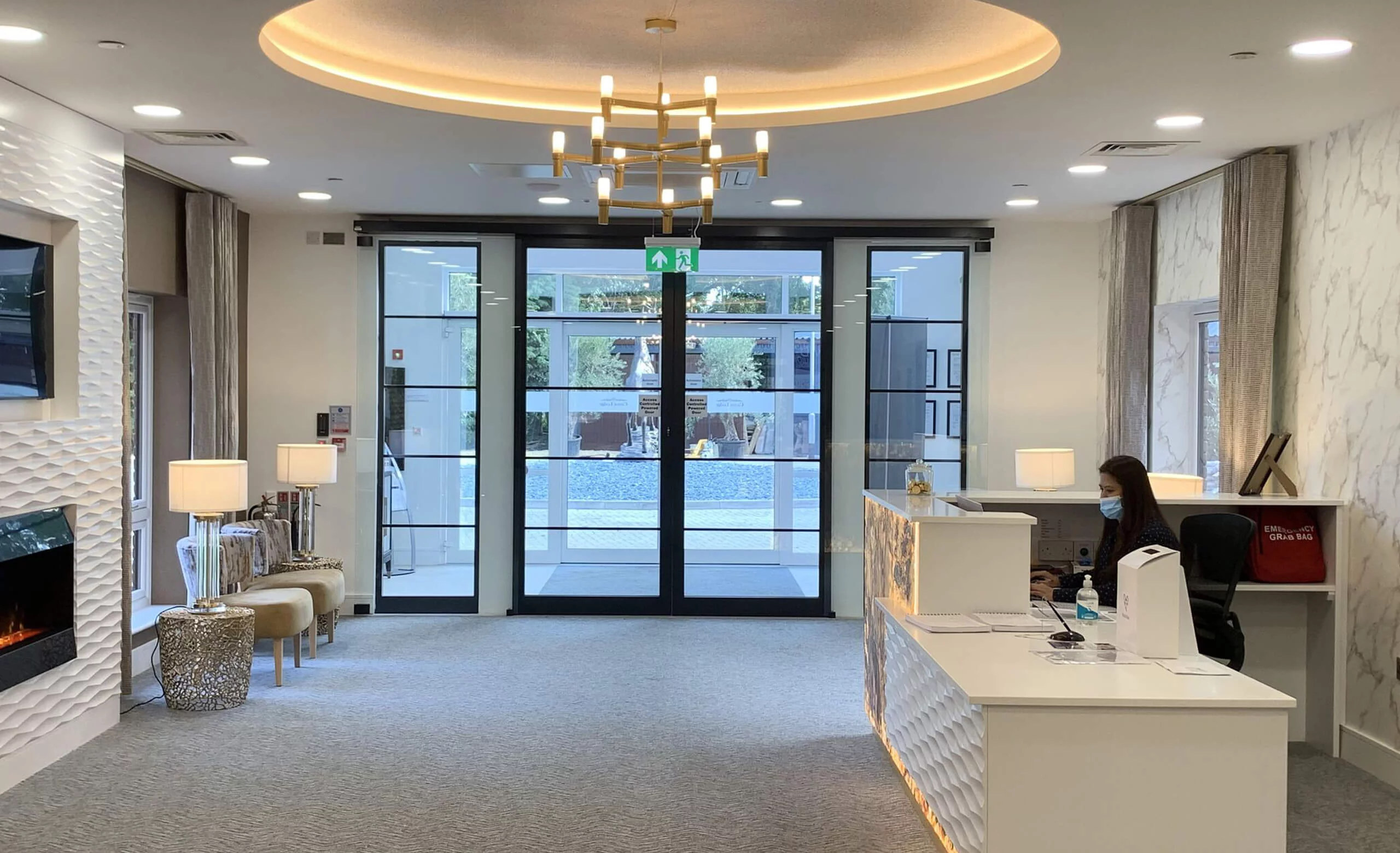 Reception at Castor Care Home with automated entrance doors and steel-look screens