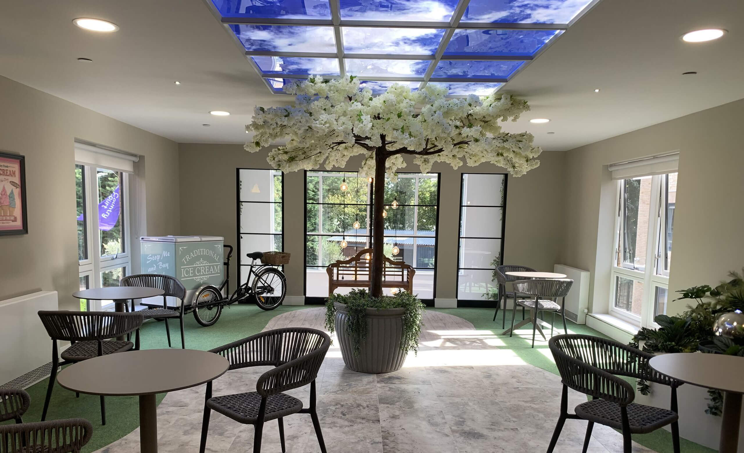 Bright residents’ lounge at Castor Care Home with full-height glazing