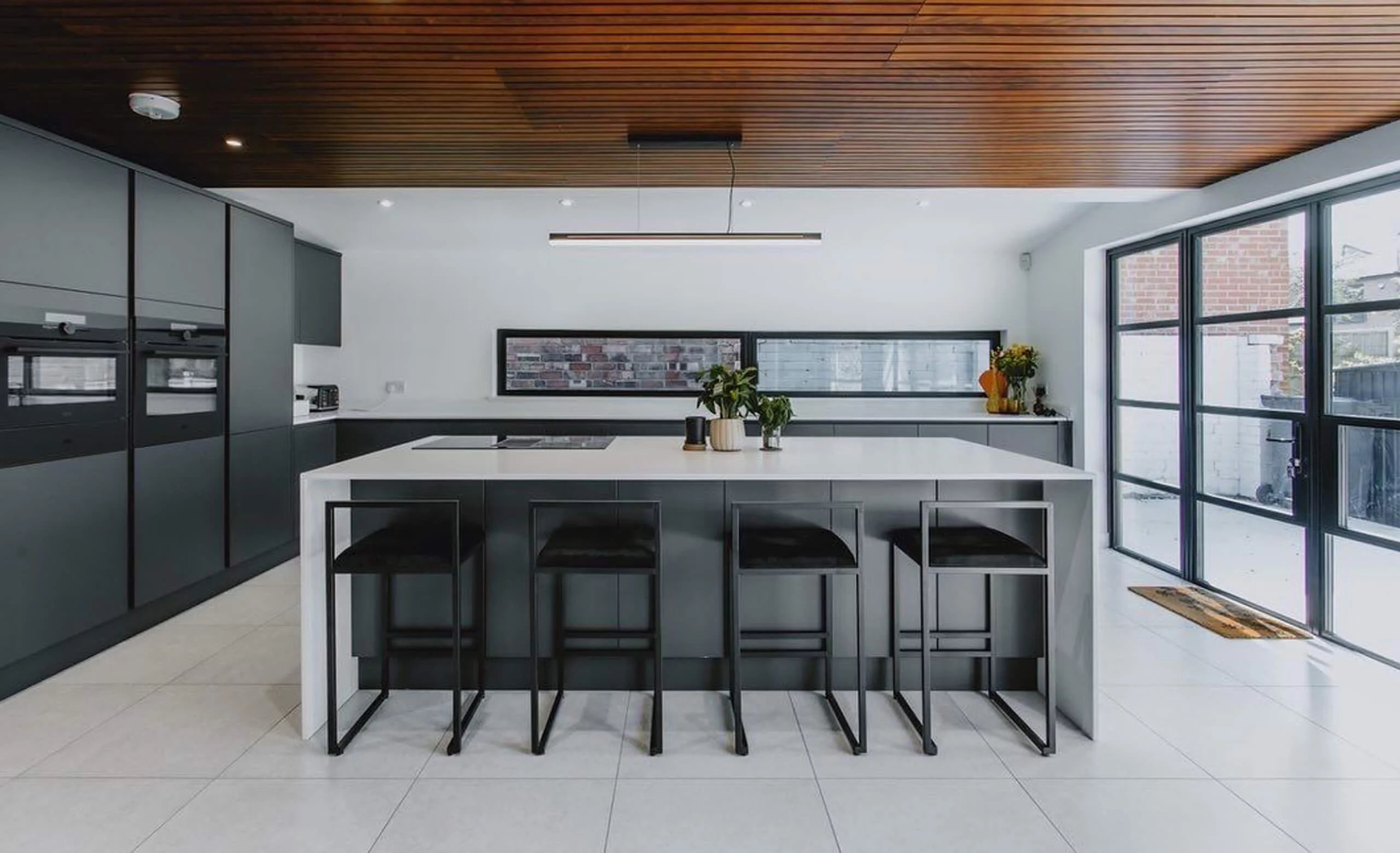 Kitchen in a West Bridgford extension with black steel-look glazing